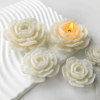 Realistic flower-shaped candles made using a silicone mould, shown with white and yellow wax finishes
