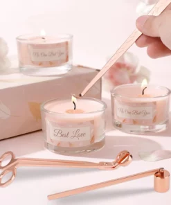 Rose gold candle accessory set with wick trimmer, dipper, and snuffer on white background